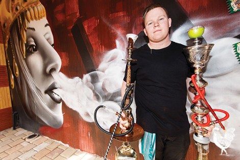 • Rotana acting manager Matthew Peters beside the controversial cafe mural. Photo by Matthew Dwyer