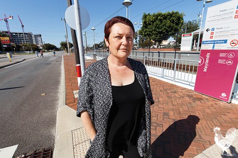 • Catherine Ehrhardt beside the zebra crossing on Railway Parade, that’s 25m from the station’s access points (people are jay walking in the background). Photo by Matthew Dwyer