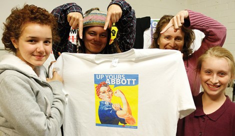 • The Socialist Alliance with their last “Up Yours Abbott” t-shirt — going for a song. Photo supplied