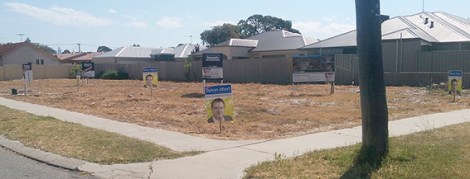 • Five posters for Sylvan Albert are scattered on this vacant lot. Photo supplied