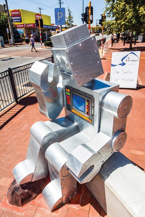 • This robot by Si Hummerston, an example of “good work” put up by Vincent council, perhaps ponders why he sits opposite some less thrilling art. Photo by Matthew Dwyer