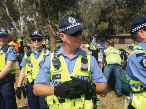 • Police form a barrier while Perth city council staff confiscate camping goods last March. Photo by Jennifer Kaeshagen