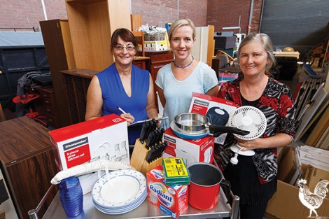 • Debbie Mason, Cr Stephanie Coates and Kaye Winfield sort through some goods for Starting Over Support. Photo by Matthew Dwyer