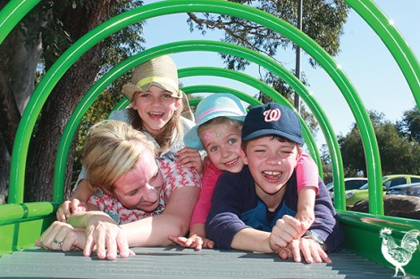 • Bayswater deputy mayor Stephanie Coates with Claudia, Esther and Oliver on Bardon Park’s new roller table. Photo by Steve Grant