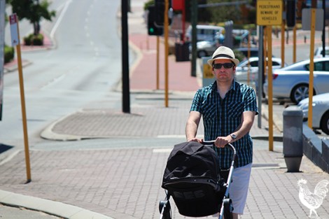 • Elli Petersen-Pik trying to shade his youngster from the harsh sun in treeless Maylands. Photo by Trilokesh Chanmugam