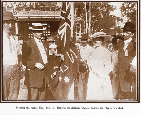 • Mrs C Roberts, the Soldiers’ Queen, hoists the flag at Anzac Cottage.
