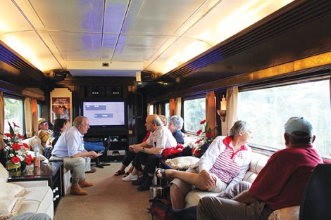 Passengers relax in the lounge car